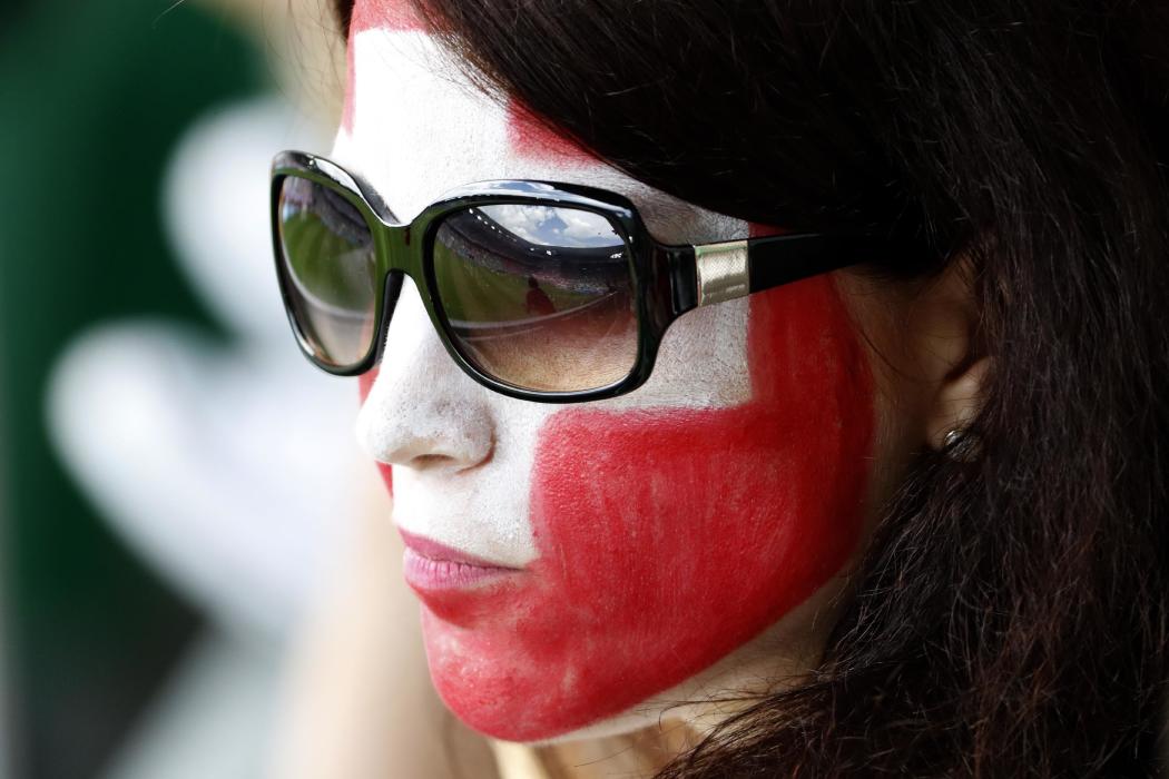 Switzerland fan with face paint before the game