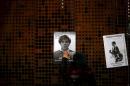 A woman touches a printed poster of U.S. citizen   Rodrigo Rojas Denegri who was burned alive during a Santiago labor strike in 1986