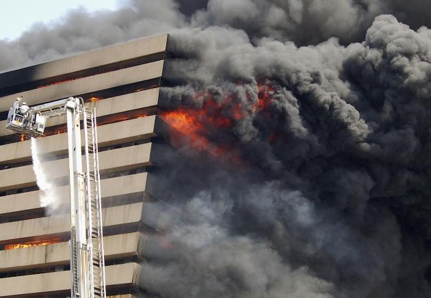 Firefighters try to douse the flames after a fire broke out in a commercial building at a textile market in Surat
