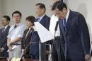 Taiwan President Ma Ying-jeou bows during a news conference with party officials after the ruling KMT party was defeated in the local elections in Taipei