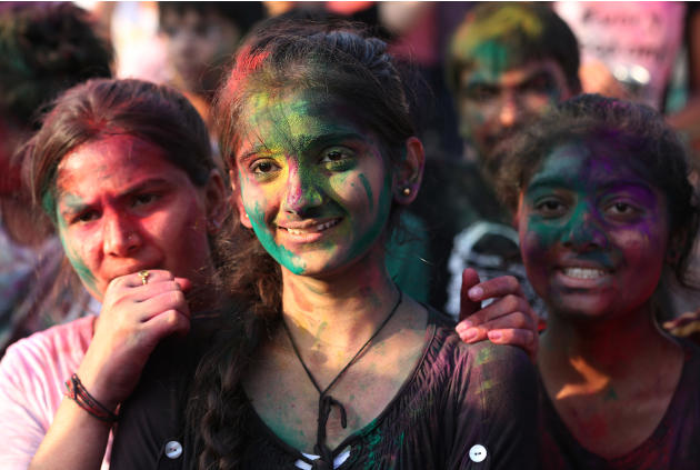 Indian nationals with colored powder on their faces participate in the celebration of the Holi festival in suburban Pasay, south of Manila, Philippines, Sunday March 16, 2014. The event is led by Indi