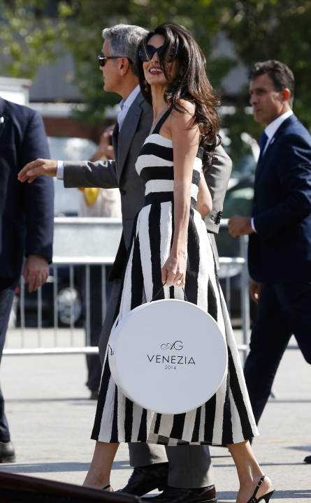 George Clooney, left, and Amal Alamuddin arrive in Venice, Italy, Friday, Sept. 26, 2014. Clooney, 53, and Alamuddin, 36, are expected to get married this weekend in Venice, one of the world's most ro