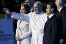 Pope Francis waves while walking with Mexico's   first lady Angelica Rivera and Mexico's President Enrique Pena Nieto after   his arrival in Mexico City