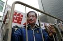 Demonstrator wears a mask depicting Causeway Bay   Books shareholder Lee Bo during a protest over the disappearance of booksellers,   in Hong Kong