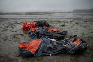 Lifeboats and life jackets recovered from the sea surrounding the 'Sewol' ferry are left on the shore near Jindo harbour where relatives of the victims are waiting for developments in the search and recovery operations on April 28, 2014
