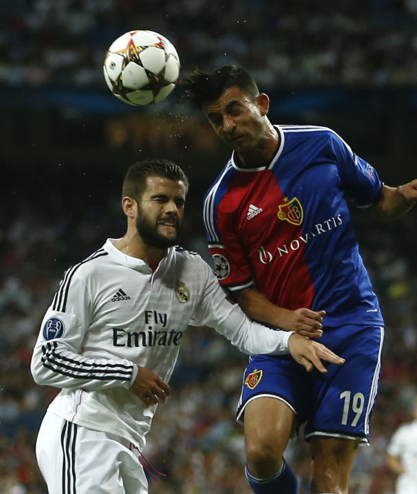 Real's Nacho vies for the ball with Basel's Behrang Safari during the Champions League Group B soccer match between Real Madrid and Basel at the Santiago Bernabeu stadium in Madrid, Spain, Tuesday, Se