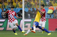 Brazil's Fred, center, falls next to Croatia's Dejan Lovren, right, as Croatia's Vedran Corluka, left, watches during the group A World Cup soccer match in the opening game of the tournament at Itaquerao Stadium in Sao Paulo, Brazil, Thursday, June 12, 2014. Brazil was awarded a penalty kick after Lovren was issued a yellow card on the play leading to a goal by Brazil's Neymar. (AP Photo/Frank Augstein)