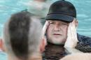 Kim Dotcom talks to supporters at his Internet Party   pool party at the Dotcom mansion in Coatesville, Auckland