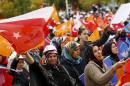 Supporters of the ruling AK Party wave national and   party flags during an election rally in Ankara