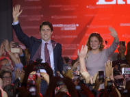 Liberal leader Justin Trudeau makes his way to the stage with wife Sophie Gregoire at the Liberal party headquarters in Montreal, Tuesday, Oct. 20, 2015. Trudeau, the son of late Prime Minister Pierre Trudeau, became Canada’s new prime minister after beating Conservative Stephen Harper. (Sean Kilpatrick/The Canadian Press via AP) MANDATORY CREDIT