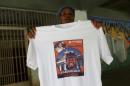 Carolina Gonzalez holds a t-shirt with a picture of   her husband Gilberto Sojo as she poses for a photo during an interview with   Reuters in Caracas