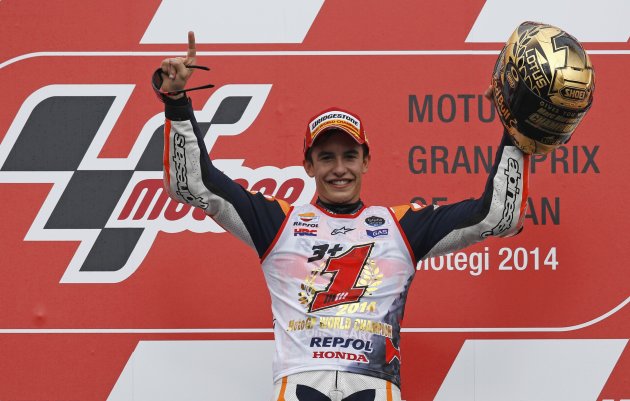 Honda MotoGP rider Marc Marquez of Spain poses on the podium after he finishes second place at the Japanese Grand Prix at the Twin Ring Motegi circuit in Motegi, north of Tokyo October 12, 2014.  Marquez retained his MotoGP title with a fighting second place finish in the Japanese Grand Prix on Sunday, the dominant Spaniard securing a fourth global title in five years at his Honda team&amp;#39;s home Motegi circuit. REUTERS/Toru Hanai (JAPAN - Tags: SPORT MOTORSPORT)