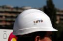 A Expo 2015 logo is pictured on the side of a security helmet of a worker as Italian Prime Minister Enrico Letta visits the construction site of Expo 2015, on the outskirts of Milan