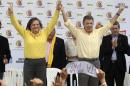 Colombia's President and presidential candidate   Santos holds hands with former presidential candidate Lopez of the Alternative   Democratic Pole party, during a campaign rally in Bogota