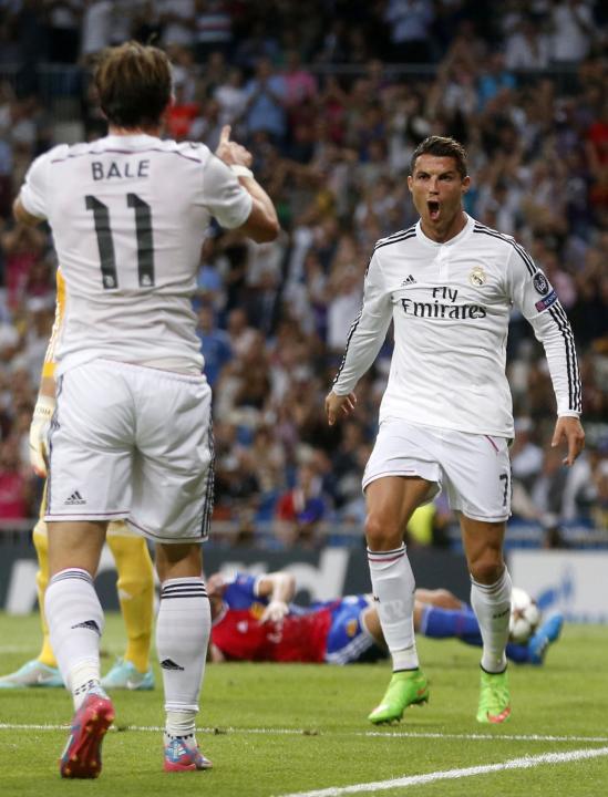 Real Madrid's Cristiano Ronaldo celebrates a goal with his teammate Gareth Bale during their Champions League soccer match against FC Basel at Santiago Bernabeu stadium in Madrid