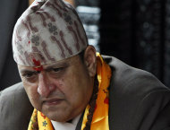 FILE - In this July 7, 2011 file photo, Nepal's former King Gyanendra listens to a supporter on his 64th birthday at his residence in Katmandu, Nepal. The last king of Nepal is in stable condition in a hospital after suffering a heart attack, doctors said Sunday, Sept. 21, 2014. (AP Photo/Binod Joshi)