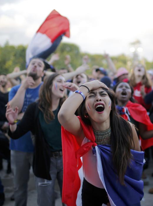 France fans react in the fan zone as they watch the EURO 2016 match in Paris