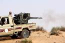 Des miliciens de Fajr Libya (Aube de la Libye) en combat contre les forces loyales aux autorités reconnues par la communauté internationale, le 25 mai 20...<br /><br />Source : <a href=