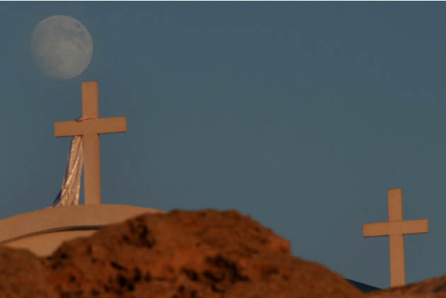 In this Monday Oct. 6, 2014 photo, moon rise over a christian Orthodox church in Ayioi Anargiroi area between popular resorts Ayia Napa and Protaras at the eastern part of Cyprus. (AP Photo/Petros Kar