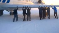Passengers Push Broken Jet On Freezing Runway