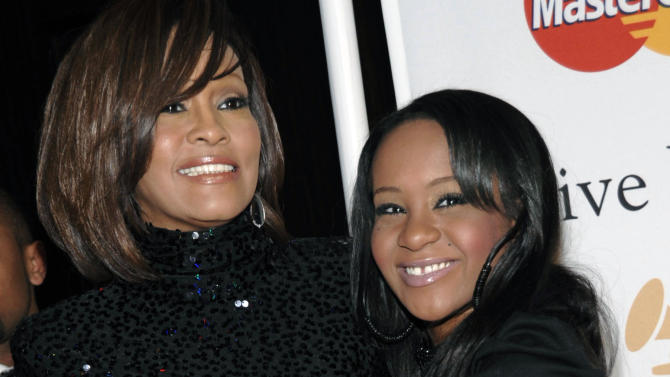 FILE - In this Feb. 12, 2011, file photo, singer Whitney Houston, left, and daughter Bobbi Kristina Brown arrive at an event in Beverly Hills, Calif. Bobbi Kristina, who dreamed of growing up to achieve fame like her mother, died in hospice care July 26, 2015, about six months after she was found face-down and unresponsive in a bathtub in her suburban Atlanta townhome. For Houston fans, the scene was grimly similar to the way her megastar mother had died three years earlier. (AP Photo/Dan Steinberg, File)