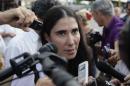 Cuba's best-known dissident, blogger Yoani   Sanchez, speaks to reporters outside Havana's Jose Marti International   Airport