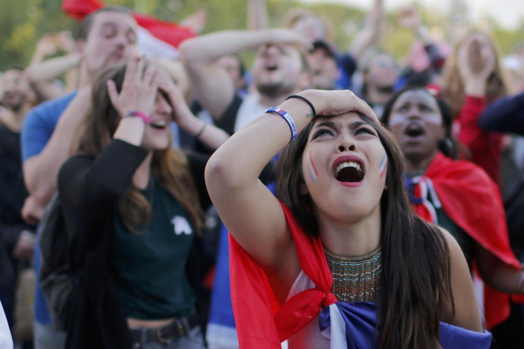 France fans react in the fan zone as they watch the EURO 2016 match in Paris