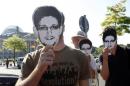 Protesters hold masks depicting former U.S. National   Security Agency contractor Edward Snowden during a demonstration in Berlin