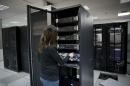 FILE- In this Nov. 19, 2015 file photo, a technician works in the servers unit at the headquarters of the Palestinian cellular network Jawwal, in the West Bank city of Ramallah. After years of delays, Israel said Thursday that it would allow the Palestinians to have their own 3G network, bringing relief to one of the last places in the world without mobile broadband services. The lack of high-speed access has been a source of frustration for young professionals, forcing many to seek creative solutions, sign up with Israeli carriers or scramble to find Wi-Fi networks. (AP Photo/Nasser Nasser, file)