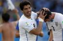 Uruguay's Luis Suarez celebrates with Uruguay's Diego Godin after winning their 2014 World Cup Group D soccer match at the Dunas arena in Natal