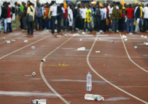 Bottles are seen strewn in front of Ghana fans after Equatorial Guinea fans threw objects during their African Nations Cup semi-final soccer match in Malabo