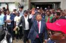 Gabonese opposition candidate Jean Ping greets   supporters outside his campaign headquarters after proclaiming that he won the   presidential election in Libreville