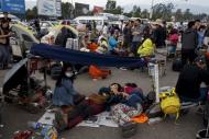 Desperate Nepalese sleep in open, seek help as aftershocks spread.