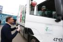 Duda, presidential candidate of the Law and Justice   Party (PiS), gives a cup of coffee to a worker in a garbage truck outside a subway   station in central Warsaw