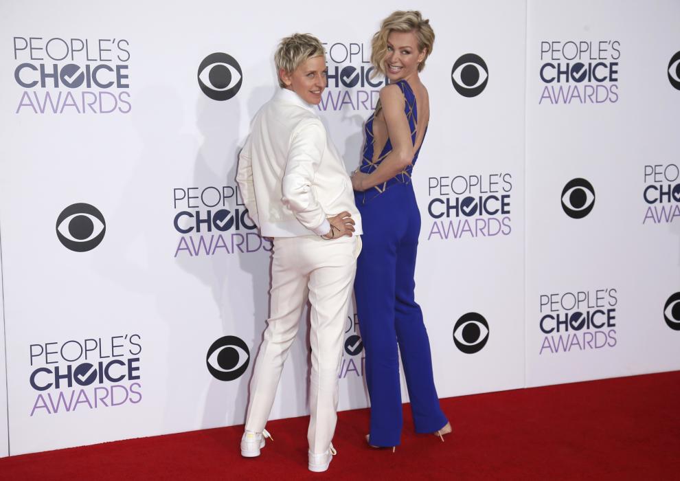 TV personality Ellen DeGeneres arrives with her spouse, actress Portia di Rossi at the 2015 People's Choice Awards in Los Angeles