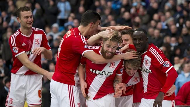 Middlesbrough&#39;s Patrick Bamford, lower second right, celebrates with teammates after scoring during the English FA Cup fourth round soccer match between Manchester City and Middlesbrough at the Etihad Stadium, Manchester, England, Saturday, Jan. 24, 2015. (AP Photo/Jon Super)