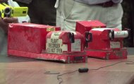 AFP TV video grab shows the two black boxes recovered from the crash site of the MH17 jet being handed over to Malaysian officials during a press conference in Donetsk on July 22, 2014