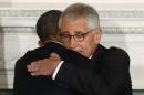 U.S. President Obama embraces Defense Secretary Hagel after announcing Hagel's resignation at the White House in Washington