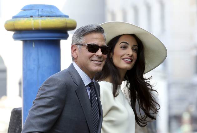 U.S. actor George Clooney and his wife Amal Alamuddin arrive at Venice city hall for a civil ceremony to formalize their wedding in Venice