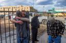 Men hug after a shooting at a motorcycle expo in   Denver, Colorado