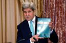 U.S. Secretary of State John Kerry holds up at copy   of the 2016 Trafficking in Persons (TIP) report during the TIP Heroes Ceremony at   the State Department in Washington