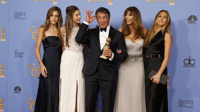 Sylvester Stallone and his family pose with his award for Best Performance by an Actor in a Supporting Role in any Motion Picture for his role in &quot;Creed&quot; backstage at the 73rd Golden Globe Awards in Beverly Hills