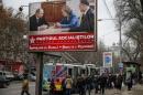 People walk near a pre-election poster for the Party of Socialists, with a picture of party members meeting with Russian President Vladimir Putin, in Chisinau