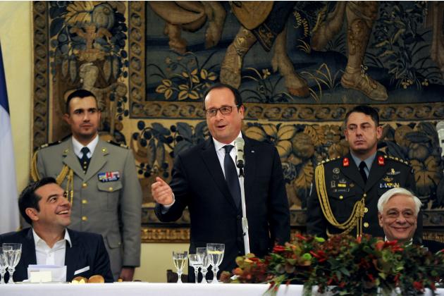 Greek PM Tsipras and Greek President Pavlopoulos smile during a speech by French President Francois Hollande during a dinner at the Presidential Palace in Athens