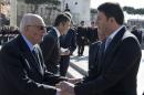 Italy's President Napolitano shakes hands with PM Renzi during a Liberation Day ceremony at the Unknown Soldier's monument in central Rome