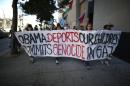 People protest against deportations of undocumented migrants and against the war in Gaza, near where President Barack Obama was speaking at Los Angeles Trade-Technical College in Los Angeles