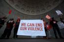 People stand in Central Park's Naumburg   Bandshell during a march against gun violence, held ahead of the third anniversary   of the Sandy Hook mass shooting in the Manhattan borough of New York City