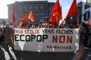 Demonstrators hold a banner reading in French "Fake ecologists, real fascists, No to ECOPOP" during a demonstration in Bern against an initiative to dramatically cut immigration numbers in the name of saving the environment