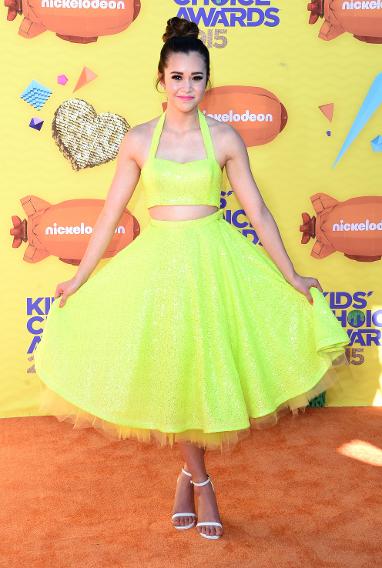 Megan Nicole in a neon crop top and flared skirt
