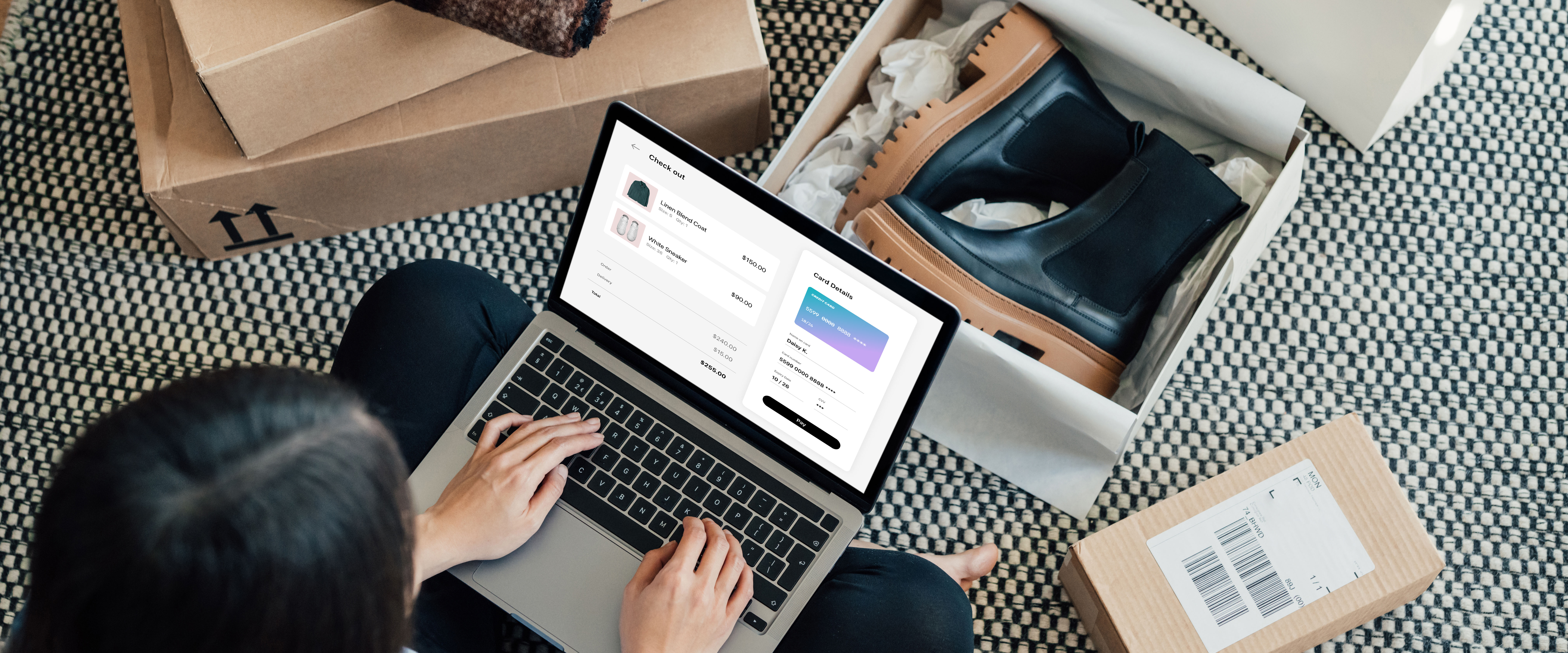 Image of a woman online shopping with a pair of boots in an open box in front of her.
